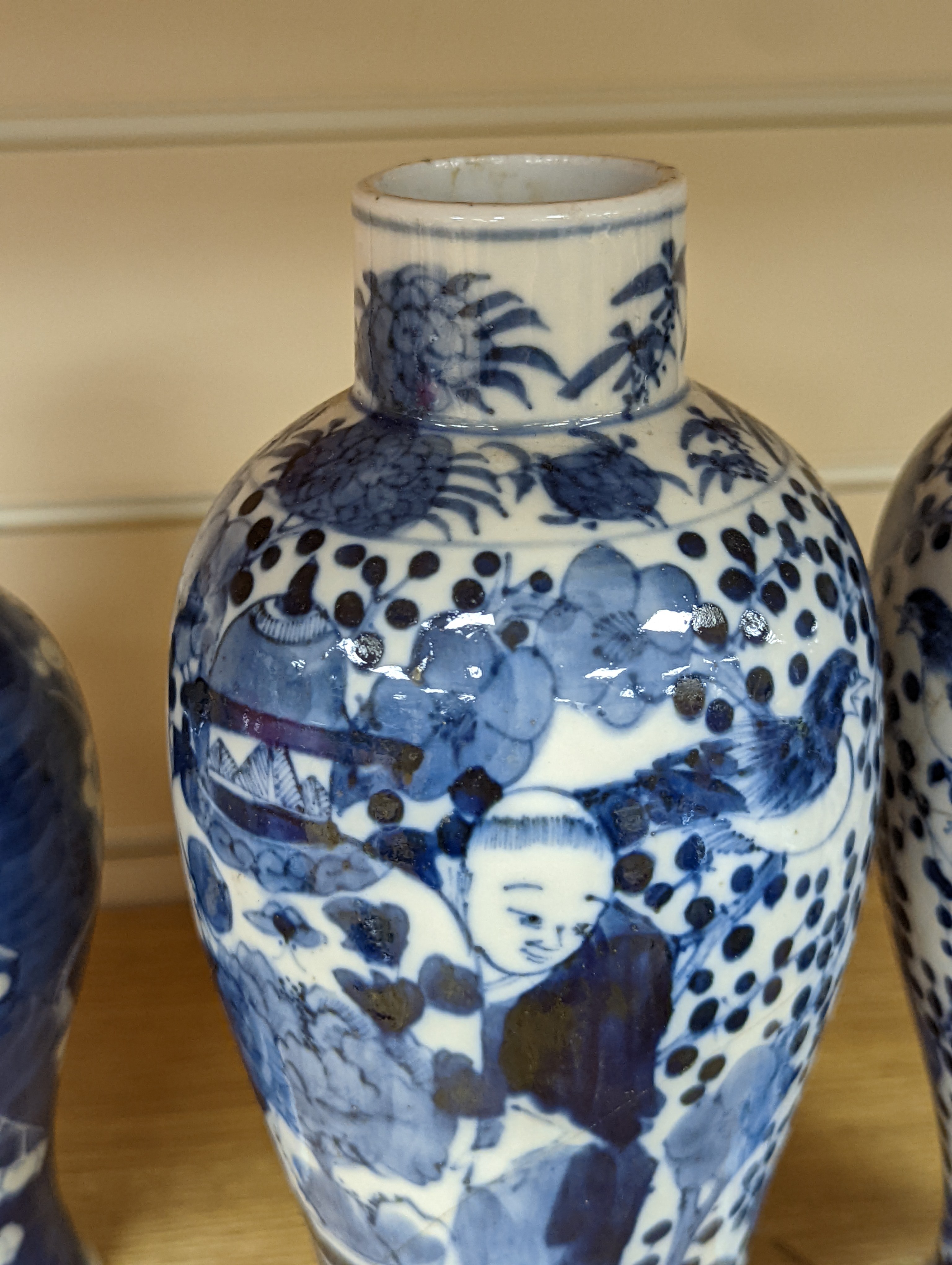 A pair of 19th century Chinese blue and white vases, a prunus vase and cover and a similar jar (4), pair of vases 24 cms high.